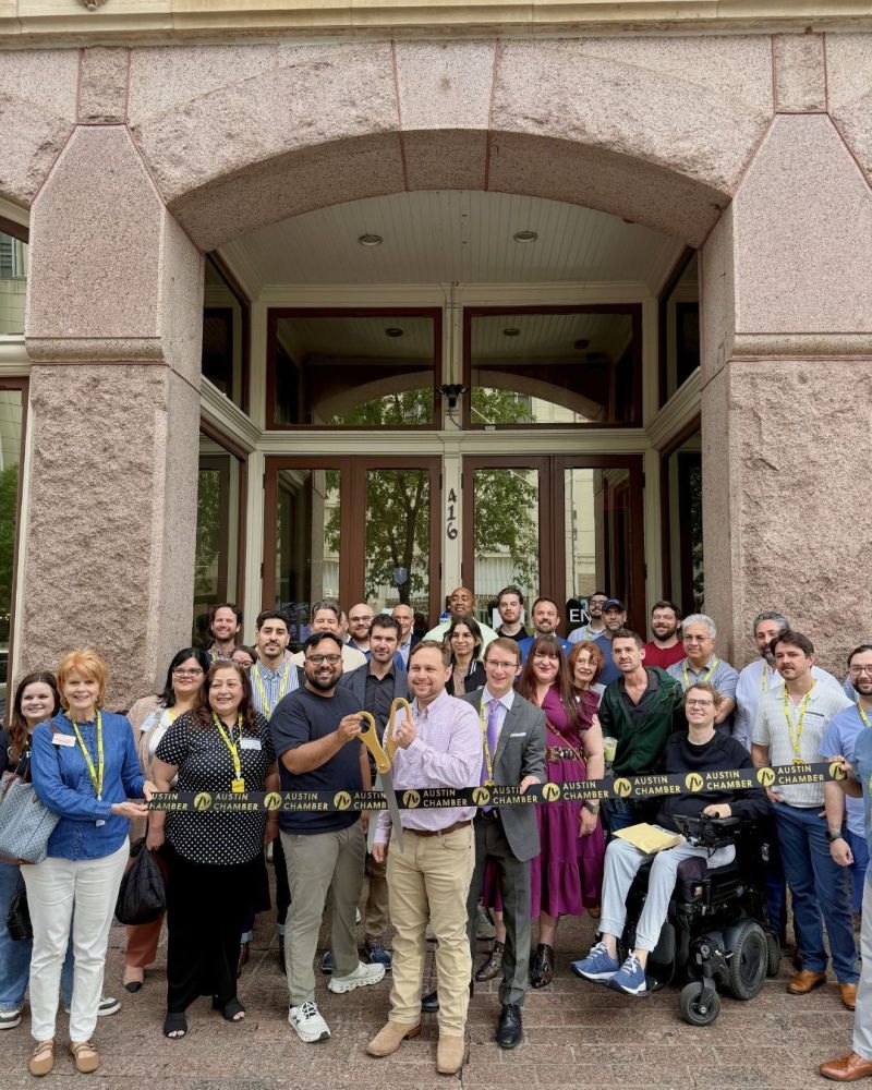 Gauntlet AI team and Austin Chamber members at the ribbon cutting outside the office