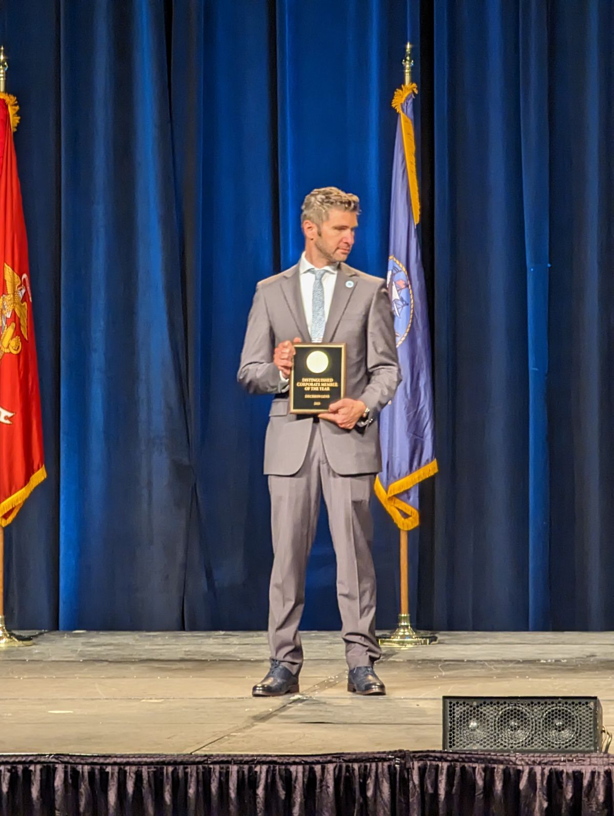 Josh Martín on stage accepting ASMC's Distinguished Corporate Member of the Year award for Decision Lens